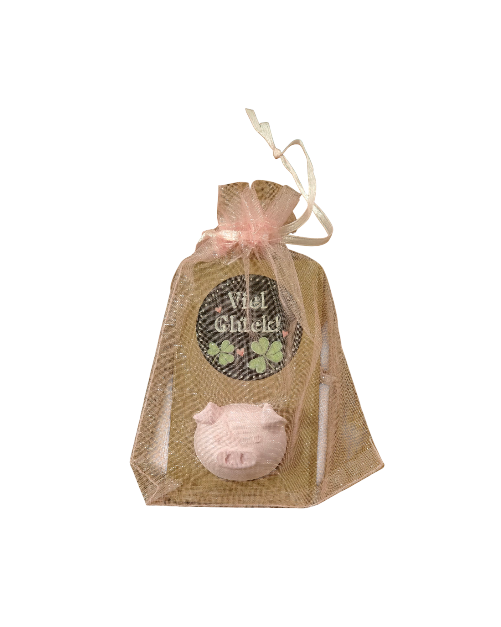 Ein Glücksbringer in Form eines Schweinchenkopfes, welcher aus Gips gegossen wurde und auf Kartonpapier befestigt ist. 